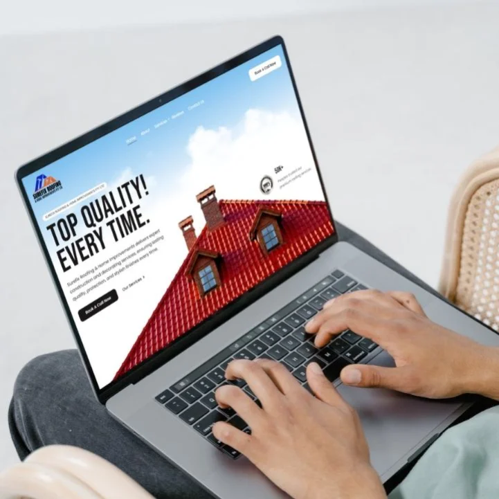 A person using a laptop displaying a high-quality roofing website designed by Million Hits, a premier web design agency in Melbourne.
